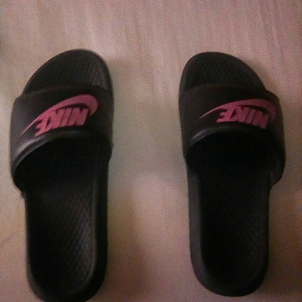 A pair of nike slides